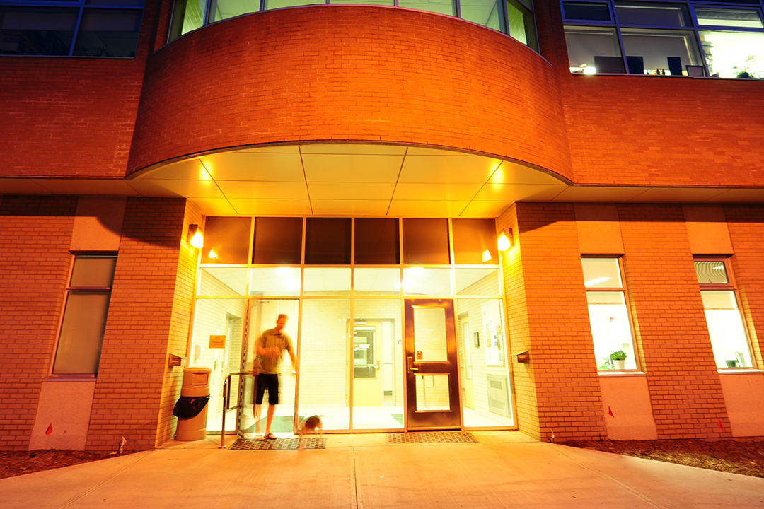 Pet owner and dog walking out of the VMC building. 